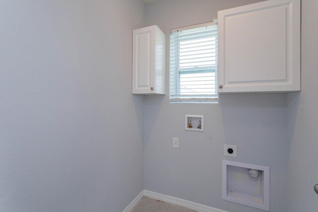 3654 Caspian St, Leesburg, FL 34748 - clothes washing area featuring hookup for an electric dryer, light tile patterned floors, hookup for a washing machine, baseboards, and cabinet space