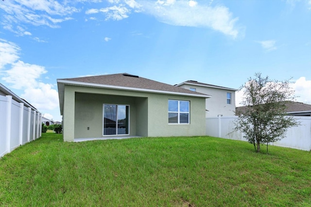 3654 Caspian St, Leesburg, FL 34748 - rear view of property featuring a fenced backyard, a shingled roof, stucco siding, and a lawn