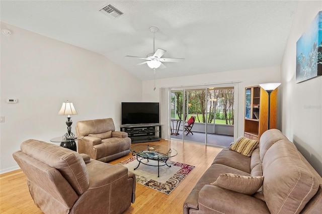 living room with light hardwood / wood-style floors, ceiling fan, and lofted ceiling