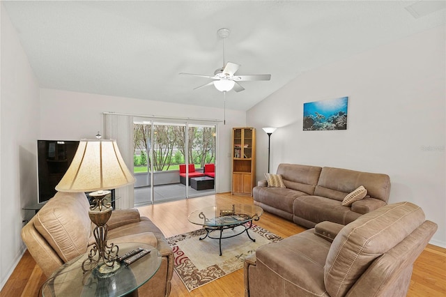 living room with ceiling fan, wood-type flooring, and vaulted ceiling