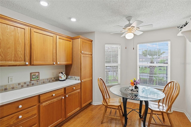 kitchen featuring a textured ceiling, light hardwood / wood-style flooring, and ceiling fan