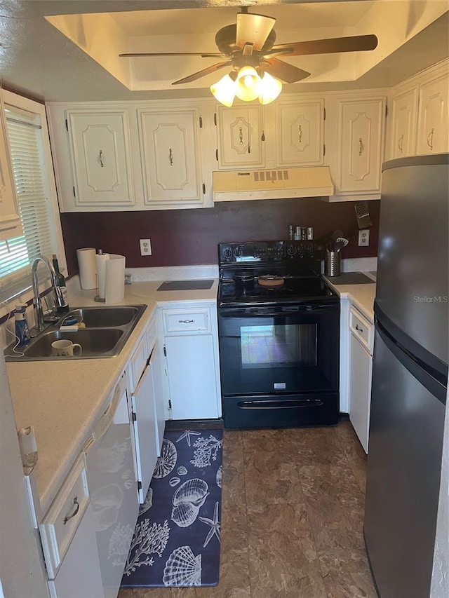 kitchen with black range with electric stovetop, sink, white cabinetry, stainless steel refrigerator, and ceiling fan