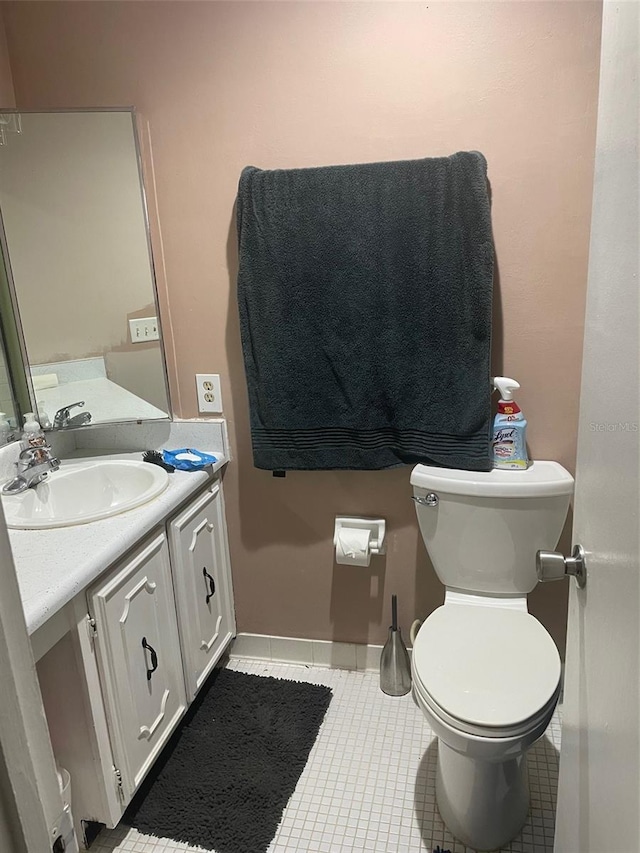 bathroom with tile patterned floors, vanity, and toilet