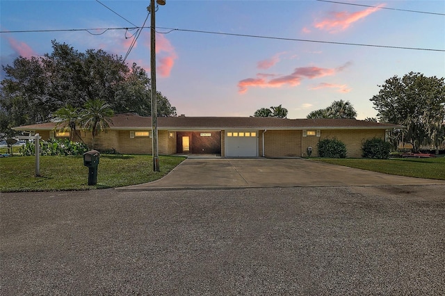 view of front of property featuring a lawn and a garage