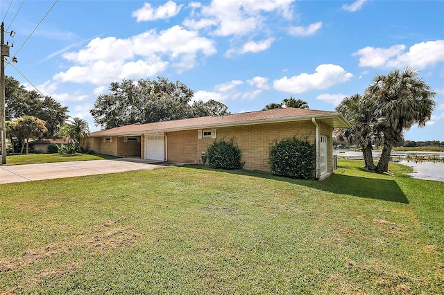 ranch-style house featuring a garage and a front yard