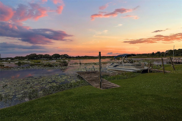 dock area featuring a yard and a water view