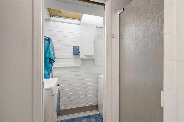 bathroom featuring electric panel and independent washer and dryer