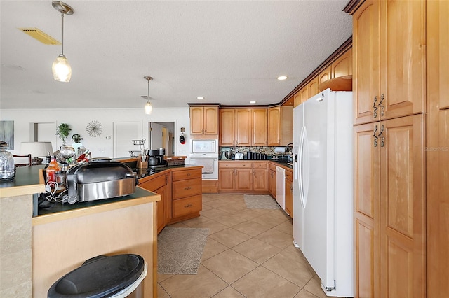 kitchen with white appliances, hanging light fixtures, a textured ceiling, tasteful backsplash, and light tile patterned flooring