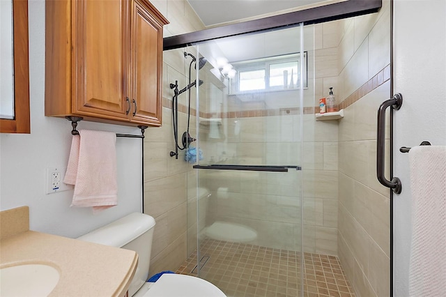 bathroom with toilet and a shower with shower door