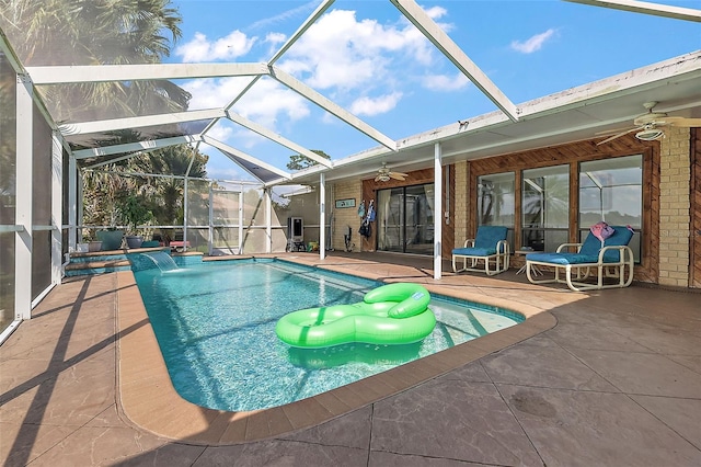 view of swimming pool featuring pool water feature, a patio area, ceiling fan, and a lanai