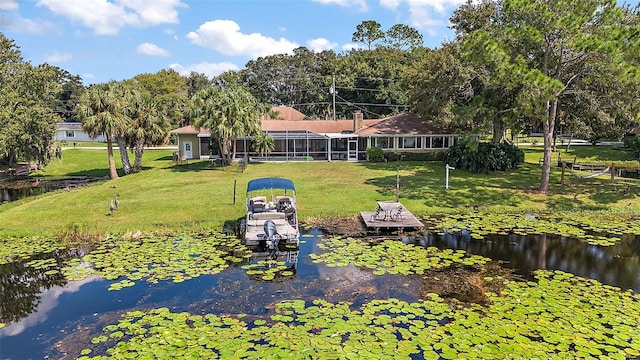 view of yard with a dock and a water view