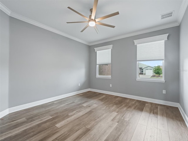 spare room with ceiling fan, ornamental molding, and wood-type flooring