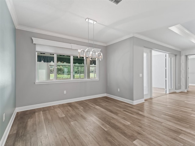 interior space featuring a notable chandelier, light hardwood / wood-style floors, and crown molding