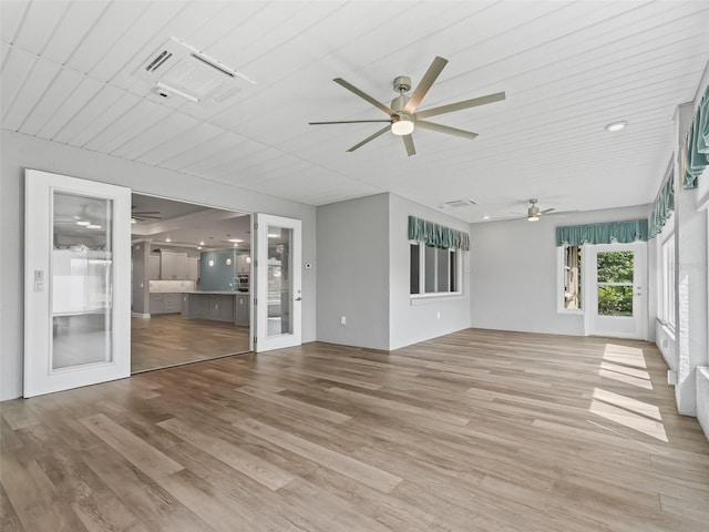 unfurnished sunroom with ceiling fan