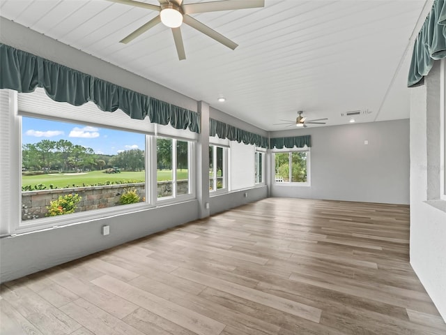 unfurnished sunroom featuring ceiling fan