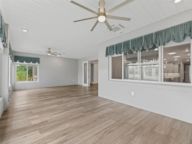 unfurnished living room featuring ceiling fan and hardwood / wood-style floors