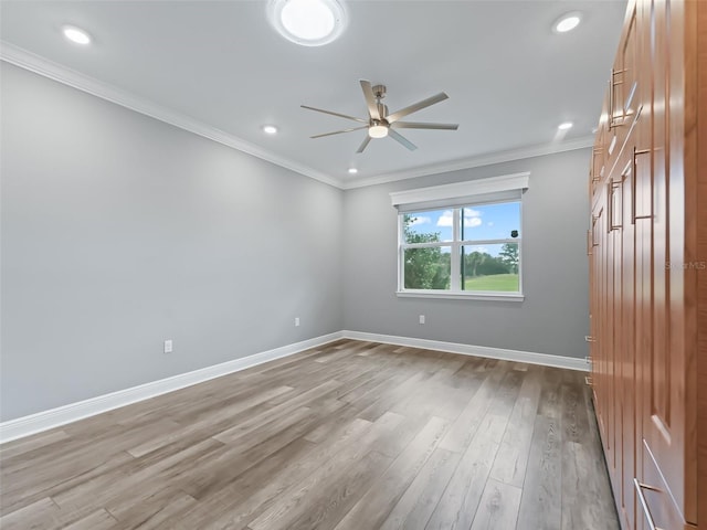 spare room with light hardwood / wood-style floors, ceiling fan, and crown molding