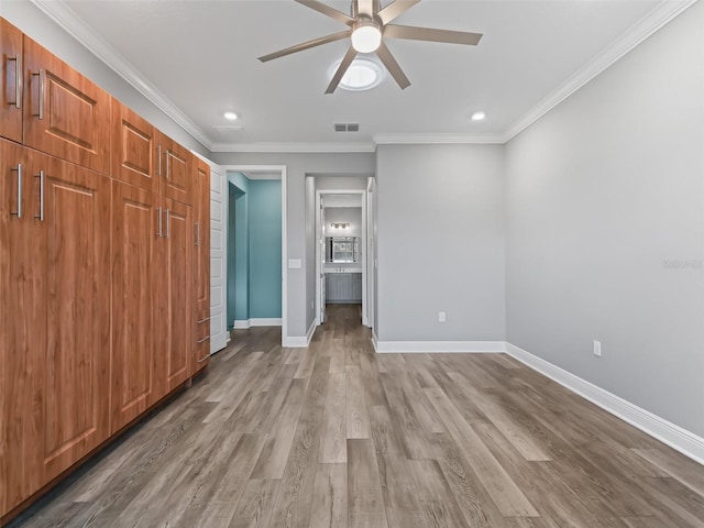 unfurnished bedroom featuring ceiling fan, ornamental molding, and light hardwood / wood-style floors