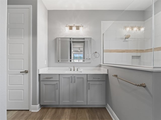 bathroom featuring a shower, vanity, and hardwood / wood-style floors