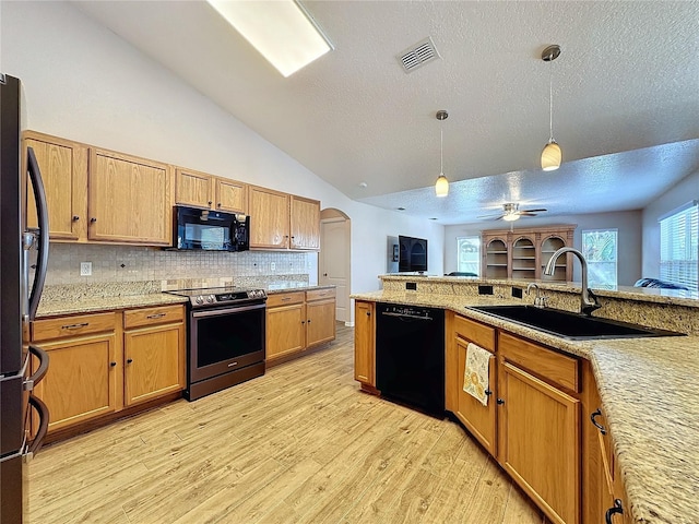 kitchen with light hardwood / wood-style floors, sink, vaulted ceiling, black appliances, and ceiling fan