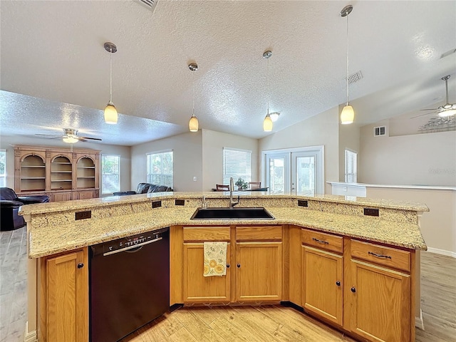 kitchen with ceiling fan, lofted ceiling, a textured ceiling, black dishwasher, and light wood-type flooring