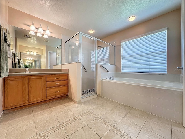 bathroom featuring a textured ceiling, vanity, and separate shower and tub