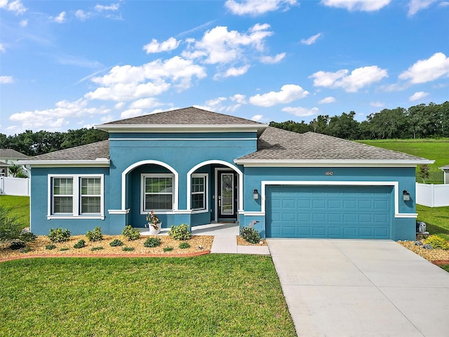 view of front of house with a garage, a front lawn, and a porch