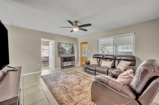 tiled living room with ceiling fan and plenty of natural light