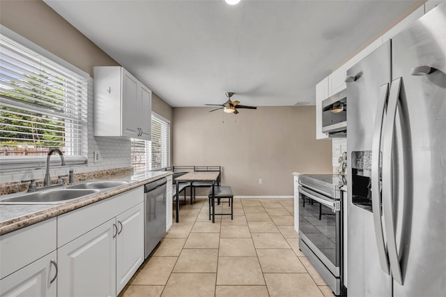 kitchen featuring white cabinetry, ceiling fan, appliances with stainless steel finishes, and sink