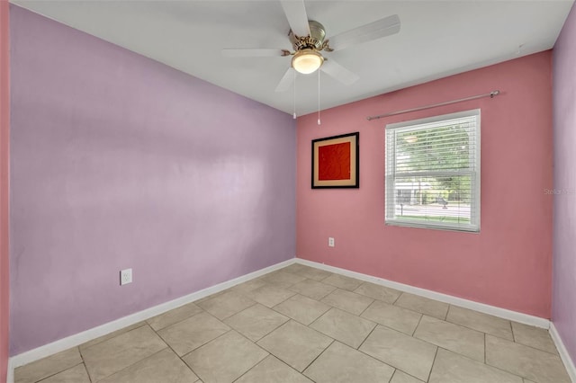 tiled spare room with ceiling fan