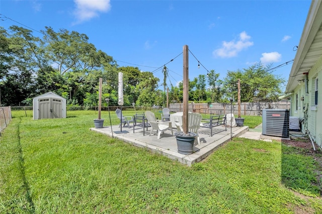 view of yard featuring a storage shed, a patio, and central air condition unit