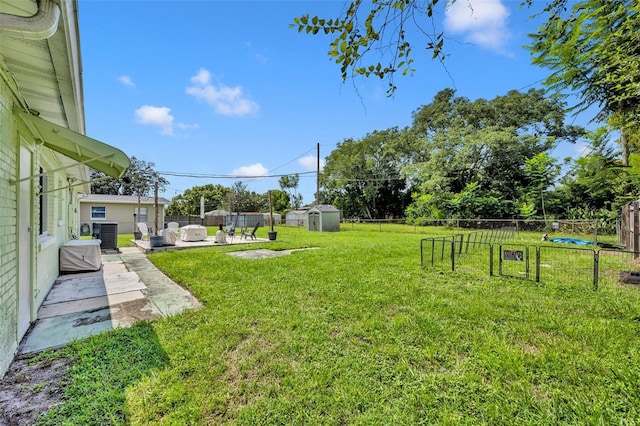 view of yard featuring cooling unit, a storage shed, and a patio area