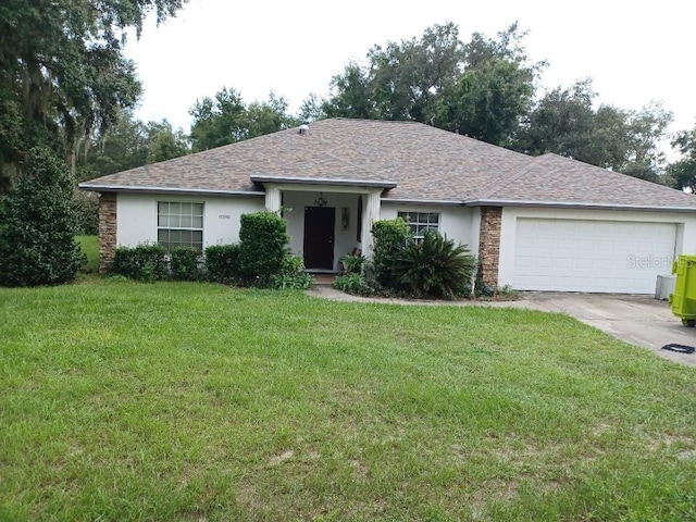 ranch-style home with a garage and a front lawn