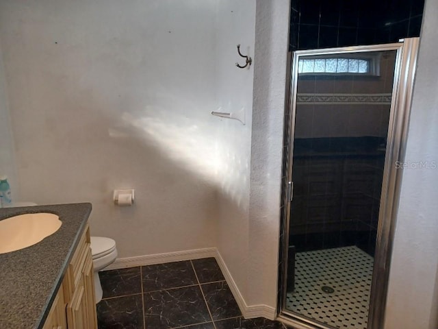 bathroom with vanity, toilet, and an enclosed shower