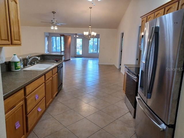 kitchen featuring sink, decorative light fixtures, light tile patterned flooring, ceiling fan with notable chandelier, and appliances with stainless steel finishes