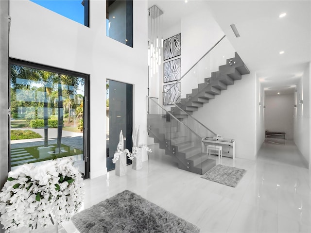 foyer featuring a towering ceiling and light tile patterned floors