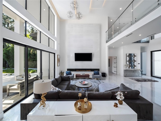 tiled living room with a fireplace and a high ceiling