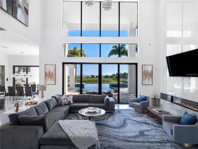 living room featuring a towering ceiling and a notable chandelier