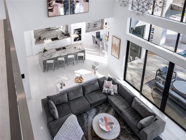 tiled living room featuring a towering ceiling