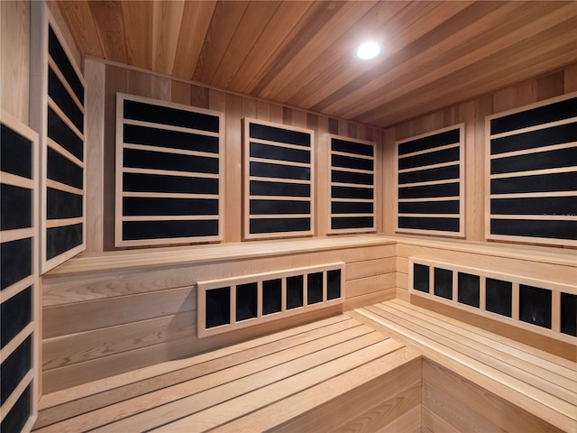 view of sauna / steam room with wooden ceiling and wood walls