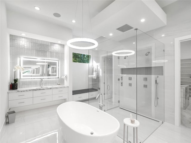 bathroom featuring tile patterned floors, independent shower and bath, and vanity