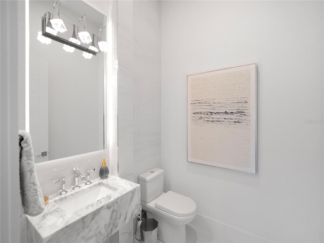 bathroom with tile patterned flooring, toilet, and sink