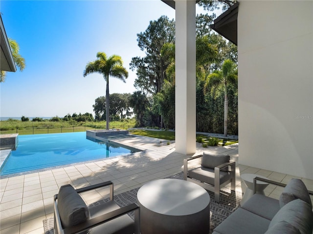 view of swimming pool with outdoor lounge area and a patio