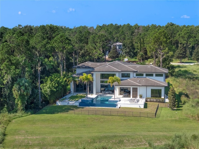 back of property featuring a lawn and a patio