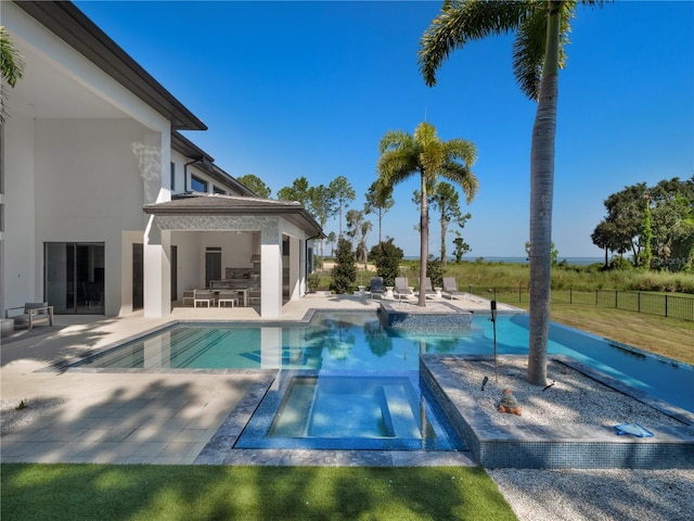 view of pool with a patio and an in ground hot tub