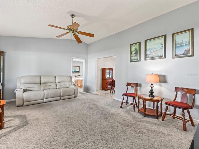 carpeted living room with ceiling fan