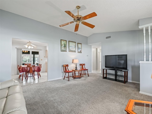 carpeted living room with ceiling fan and lofted ceiling