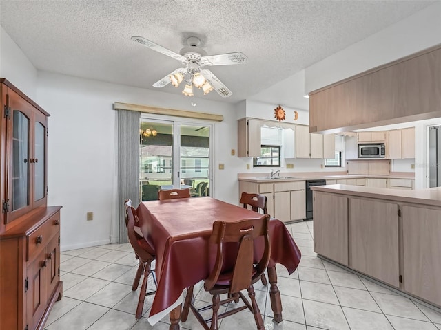 tiled dining room with ceiling fan, a textured ceiling, and a healthy amount of sunlight