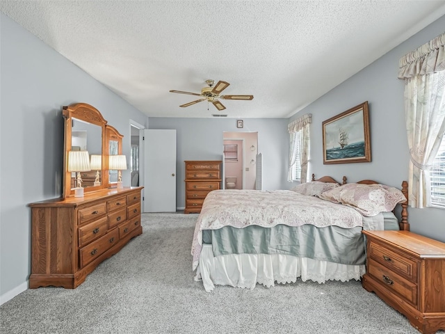 carpeted bedroom with a textured ceiling and ceiling fan