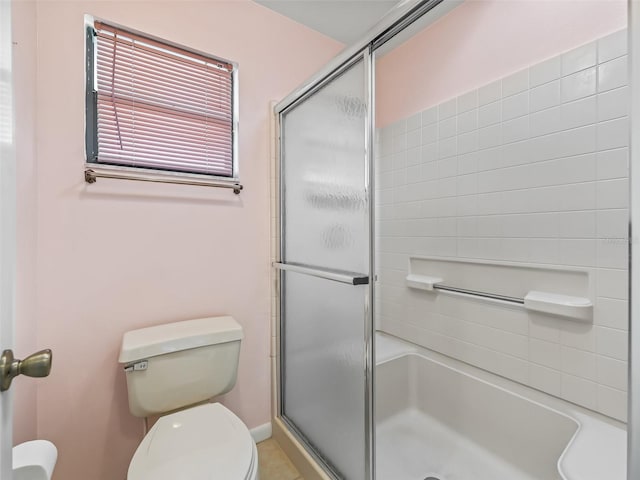 bathroom featuring an enclosed shower and toilet